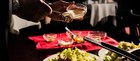 Hands preparing a traditional Caesar Salad tableside