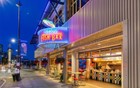 A neon lit Anthonys Fish Bar at night