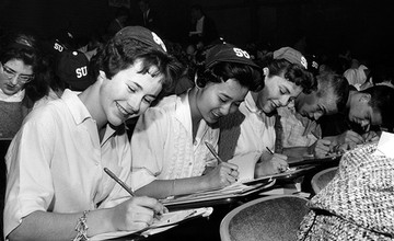 Women in early Seattle University classroom, wearing SU beanies
