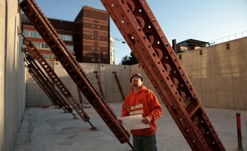 A man standing in front of a construction site.