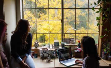 Students studying in a room with a window