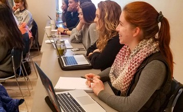 Students in classroom  with computers and notebooks