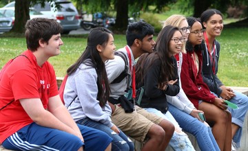 Students sitting on a campus bench