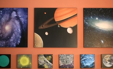 A room with a variety of planets on the wall.