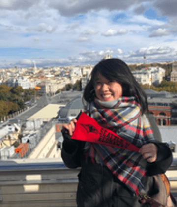 Woman holding a Seattle U flag