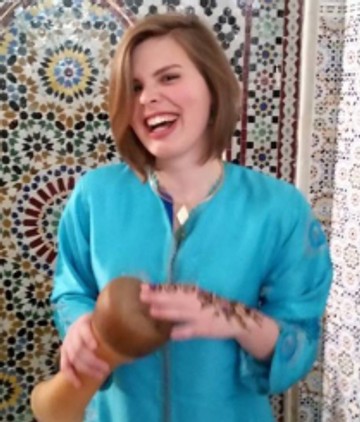 Woman playing a small drum