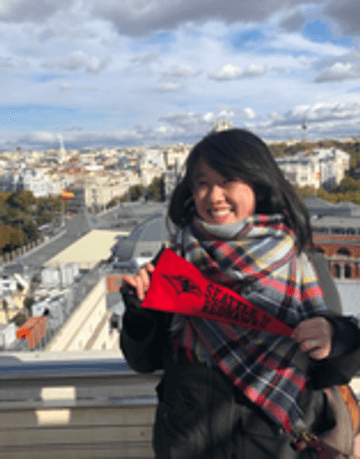 Woman holding a Seattle U flag