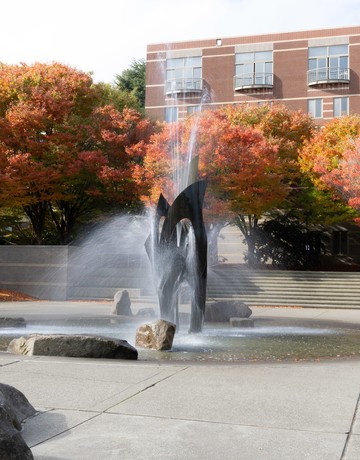 Photo of fountain with trees in background