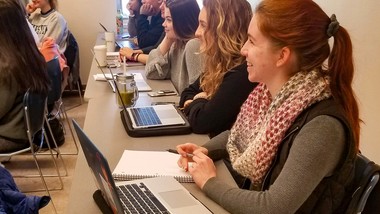 Students in classroom  with computers and notebooks