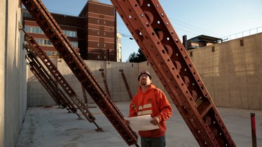 A man standing in front of a construction site.