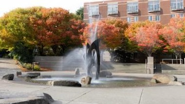 Photo of fountain with trees in background