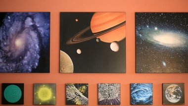 A room with a variety of planets on the wall.