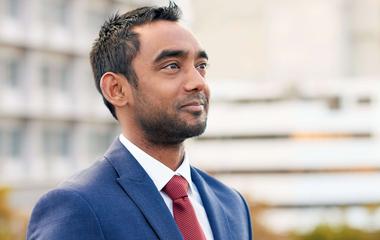 A South Asian executive looking right