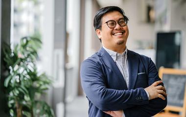 A smiling student in glasses