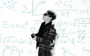 A student at projects day with math equations behind them