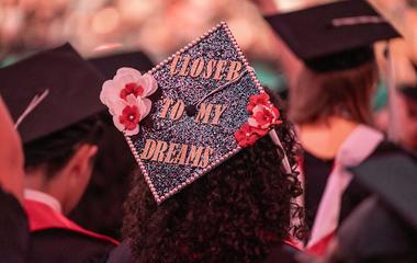 Graduate with mortar board text closer to my dreams