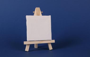 Miniature easel and fliipchart on blue background