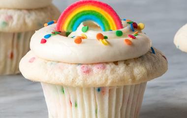 A cupcake with a rainbow topper