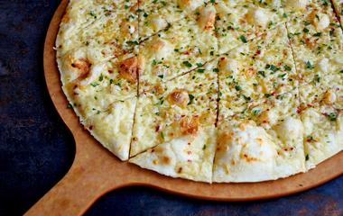 A pizza peel with a pizza on top