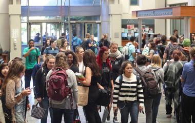 Students milling about the atrium of Pigott Building