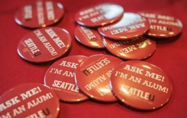 Homecoming buttons saying Ask Me I'm an Alum