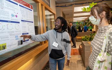 Student presenting a poster on their research
