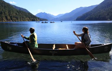 Two students row in a canoe on a lake