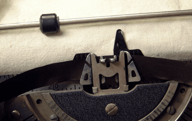 Old typewriter with blank paper in it