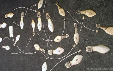 Photo of bronze dance steps embedded in the sidewalk of Broadway near campus
