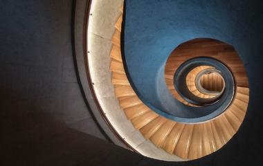 Spiral staircase with warm lighting on wooden treads