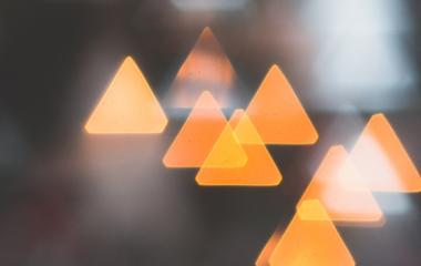 Bokeh image of triangular lights pointing upward