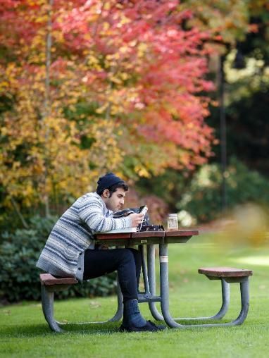 A man sitting at a picnic table.