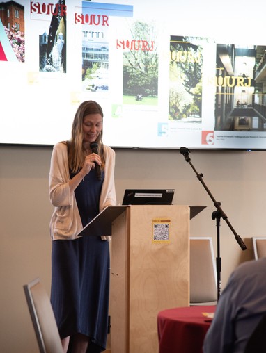 Student presenting at a podium at the SUURJ conference