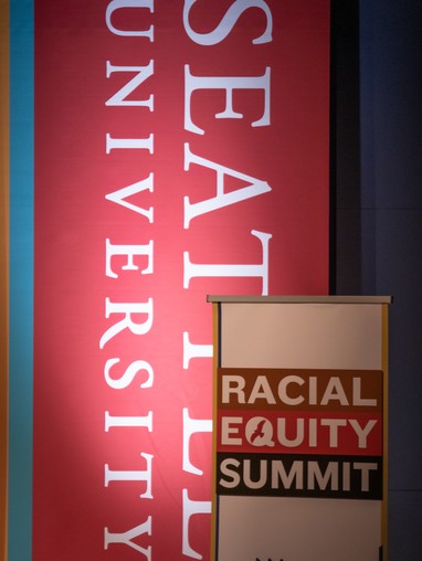 Stage in Pigott Auditorium with Racial Equity Summit banners on it