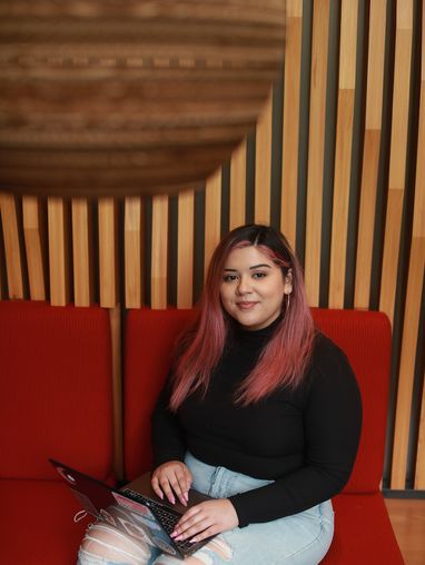 a student sitting on a red couch