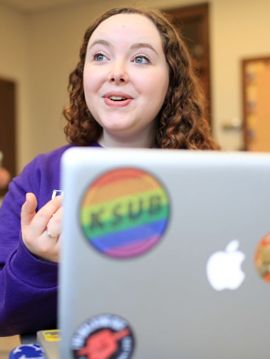 A woman sitting in front of a laptop.