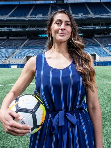 A grad student holding a soccer ball