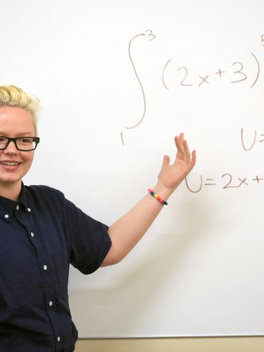 student studying and teaching on whiteboard