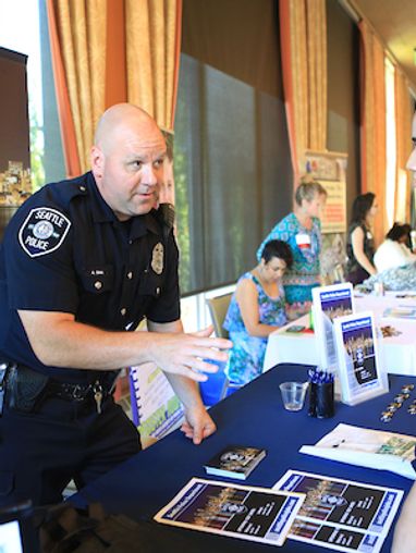 Police officer talking to student at a job and internship fair