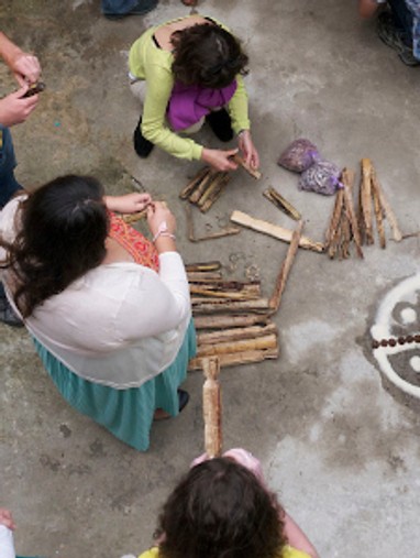 People from specific culture doing art on the ground