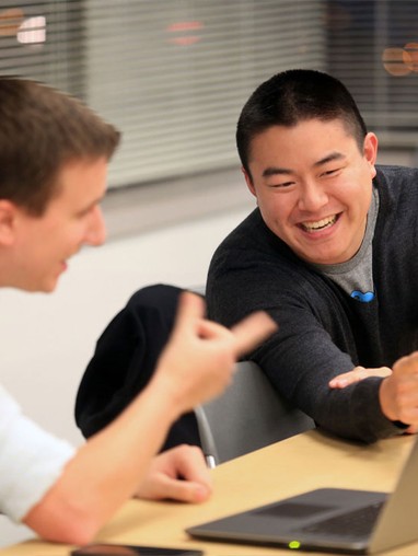 Two students laughing