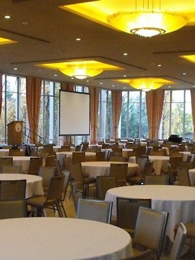 A large conference room with tables and chairs.