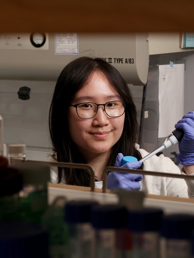 smiling student with lab gloves