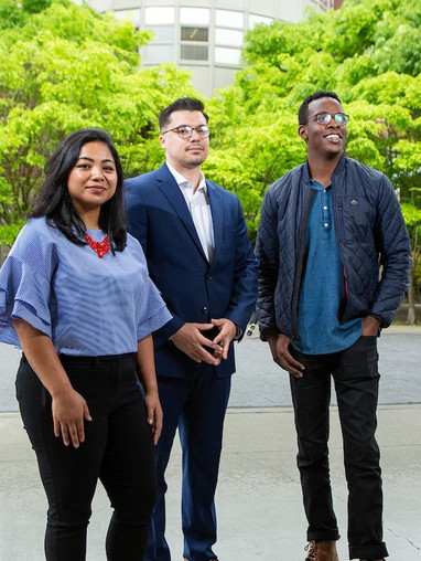 Three law students standing on the lower mall