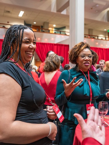 Two women laughing at event