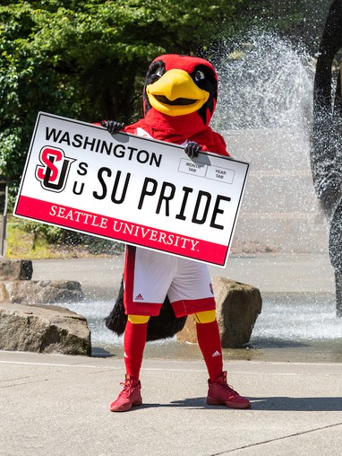 Rudy holding an SU Pride License Plate