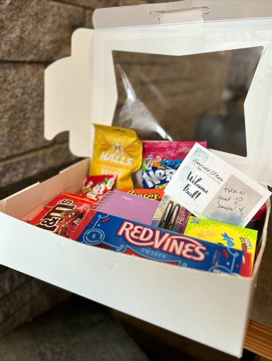 white cardboard box filled with various candy bars