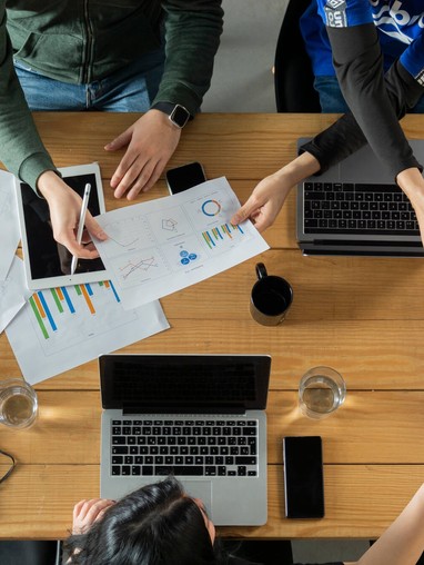 Three office workers collaborating on a project