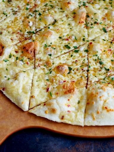A pizza peel with a pizza on top