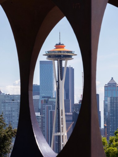 A view of the seattle skyline through a series of circular holes.